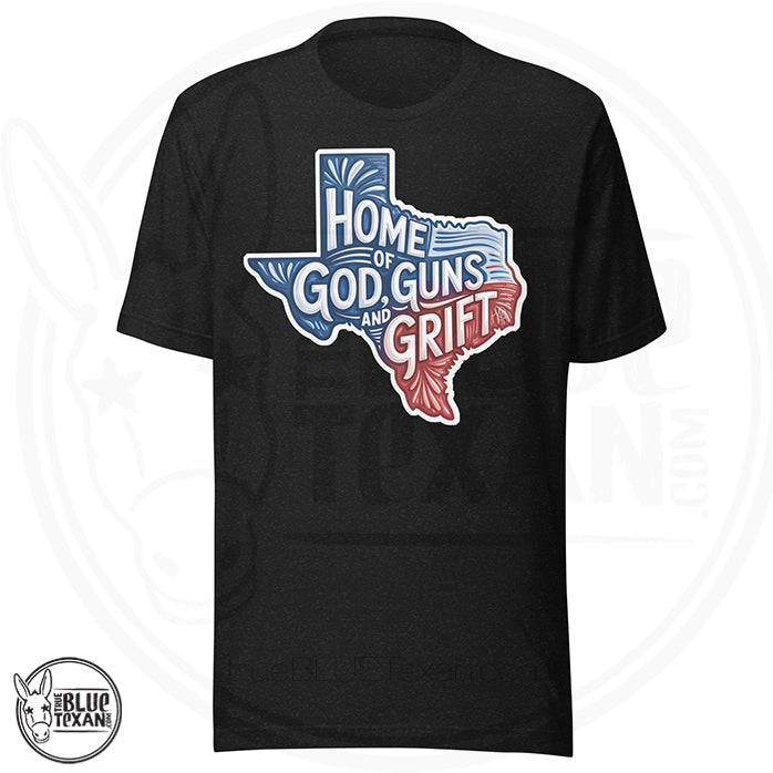 Black t-shirt with a graphic of Texas and text 'Home of God, Guns and Grift' on a white background.