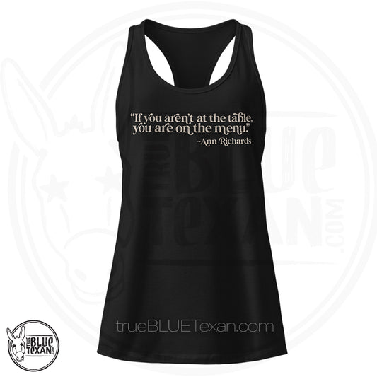 "If you aren't at the table, you are on the menu Ann Richards" quote women's racerback tank top in black