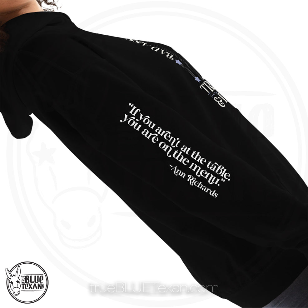 Bad Ass, Liberal, Feminist, Trailblazer, Hellraiser. Texas Governor Ann Richards premium unisex hoodie sweatshirt in black The arm features the quote "If you aren't at the table. you are on the menu."