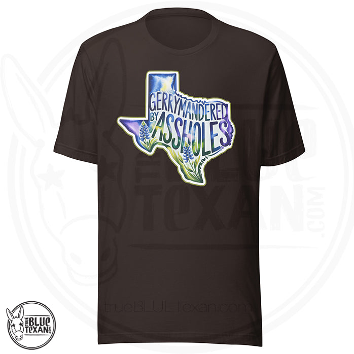 premium unisex tshirt with  the shape of Texas featuring Bluebonnet flowers that says "Gerrymandered by Assholes"  in brown