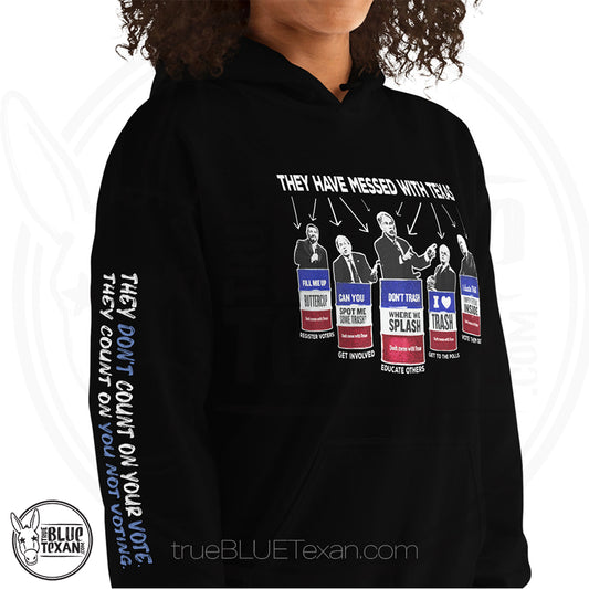 They Have Messed with Texas Trash the Texas GOP Unisex Hoodie featuring Texas GOP Greg Abbott, Dan Patrick, Ken Paxton, Ted Cruz, John Cornyn in Don't Mess with Texas Trash Cans in Black w quote they don't count on your vote, they count on you not voting